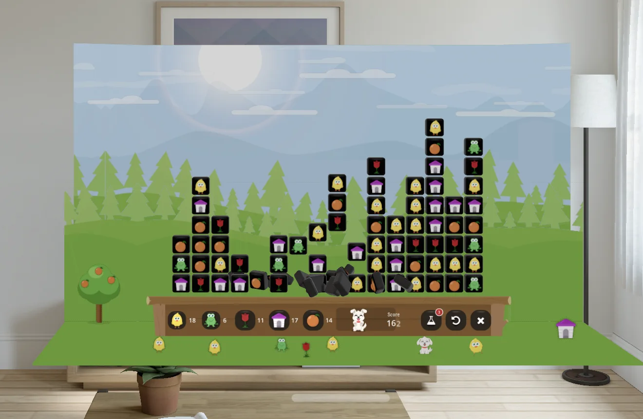 A game on GAME's table on Apple Vision Pro: cleared tiles tumbling off the board, with chicks, a frog, a tulip, a tree and the dog on the grass in front